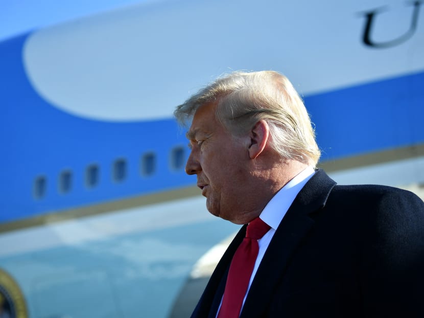 US president Donald Trump speaks to the media as he makes his way to board Air Force One before departing from Andrews Air Force Base in Maryland on Jan 12, 2021. Mr Trump is travelling to Texas to review his border wall project.