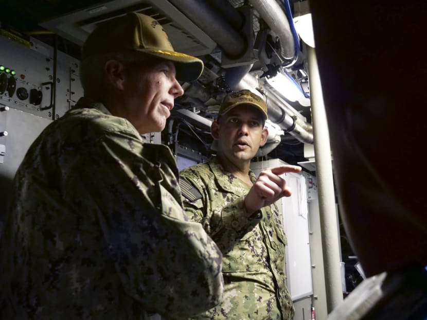 United States Navy Commander Cameron Aljilani (right) and two others were removed from their positions following an investigation into the crash in the disputed South China Sea.