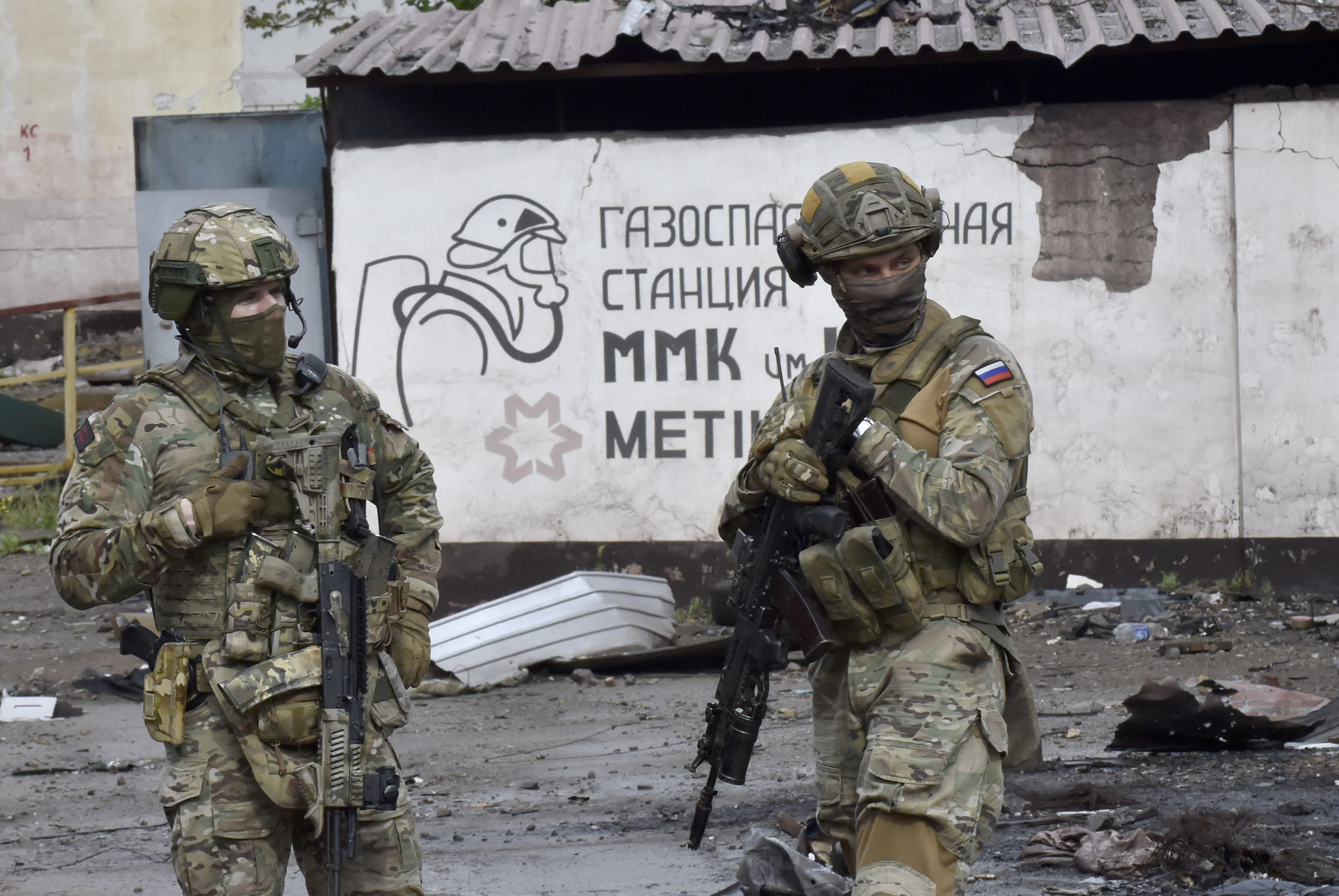 Russian servicemen stand guard at the destroyed part of the Ilyich Iron and Steel Works in Ukraine's port city of Mariupol on May 18, 2022, amid the ongoing Russian military action in Ukraine. Russian servicemen stand guard at the destroyed part of the Ilyich Iron and Steel Works in Ukraine's port city of Mariupol on May 18, 2022, amid the ongoing Russian military action in Ukraine.