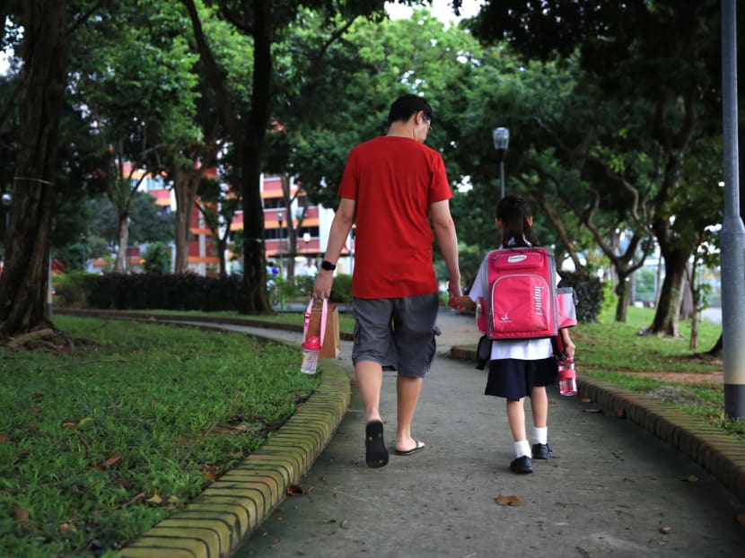 A parent sending his child to school. The Ministry of Education announced a raft of changes aimed at reducing emphasis on grades, and parents lauded the move, saying that having fewer exams will help reduce the stresses students face.
