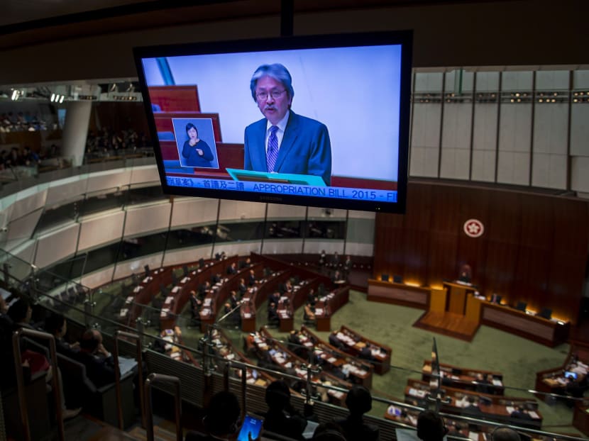 Financial Secretary John Tsang is seen on a screen as he delivers his annual budget report at the Legislative Council in Hong Kong today (Feb 25). Photo: Reuters