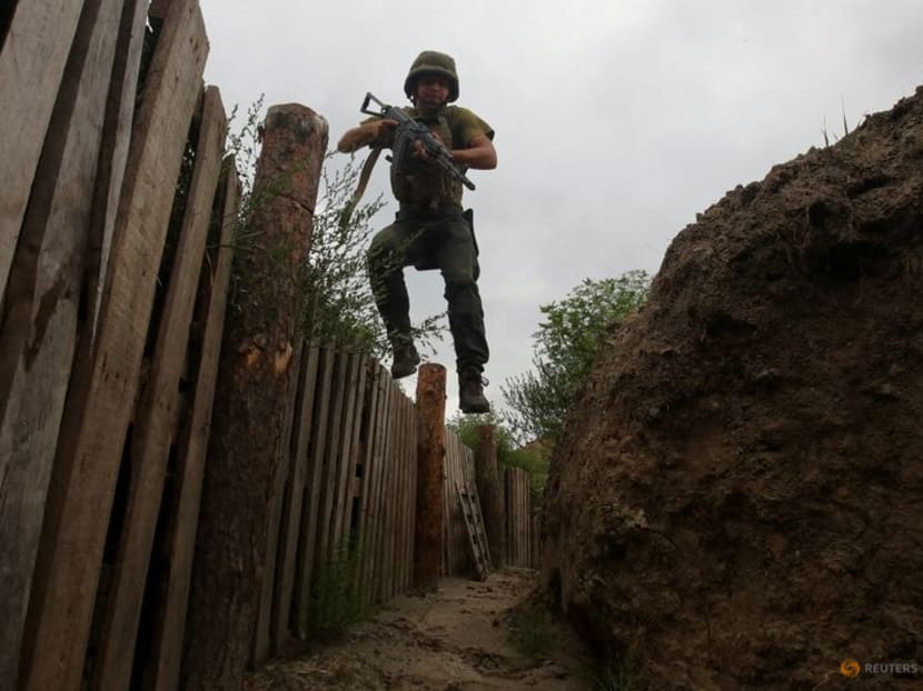 FILE PHOTO: A member of the Ukrainian National Guard jumps into a trench at a position near a front line, as Russia's attack on Ukraine continues, in Kharkiv region, Ukraine August 3, 2022. REUTERS/Vyacheslav Madiyevskyy/File Photo FILE PHOTO: A member of the Ukrainian National Guard jumps into a trench at a position near a front line, as Russia's attack on Ukraine continues, in Kharkiv region, Ukraine August 3, 2022. REUTERS/Vyacheslav Madiyevskyy/File Photo