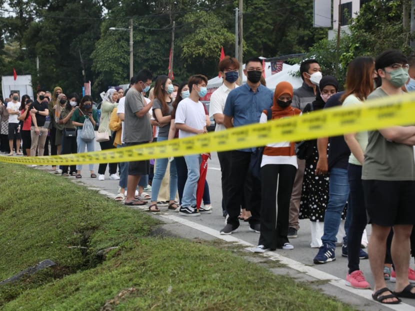 People waiting in line outside a polling centre in Tambun to cast their votes in Malaysia’s 15th general election on Nov 19, 2022.