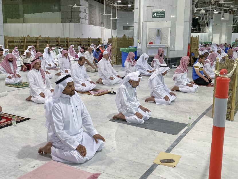Muslim worshippers perform the "Tarawih" nightly prayer during the holy month of Ramadan, while keeping their distance amid the Covid-19 pandemic, at the Grand Mosque, Islam's holiest site, in the Saudi city of Mecca, late on May 8, 2020.