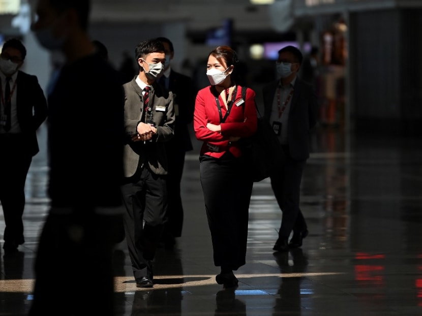 Cathay Pacific employees walk through Hong Kong International Airport in Hong Kong on Oct 21, 2020, after the flag carrier airline announced that 6,000 staff would lose their jobs due to the Covid-19 pandemic. Cathay Pacific employees walk through Hong Kong International Airport in Hong Kong on Oct 21, 2020, after the flag carrier airline announced that 6,000 staff would lose their jobs due to the Covid-19 pandemic.