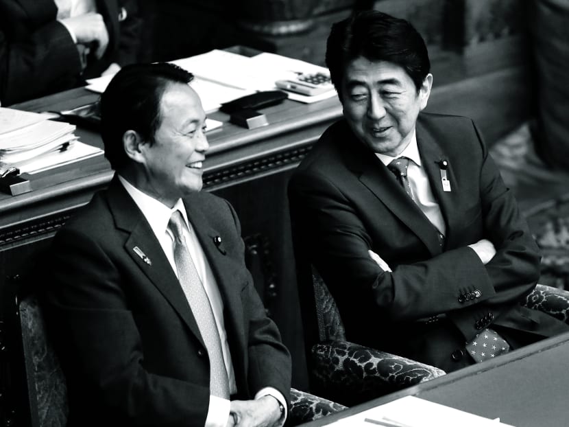 It will be no laughing matter for Mr Taro Aso (left) and Mr Shinzo Abe if the government’s reflationary policies fail to breathe new life into Japan’s economy. Photo: Bloomberg