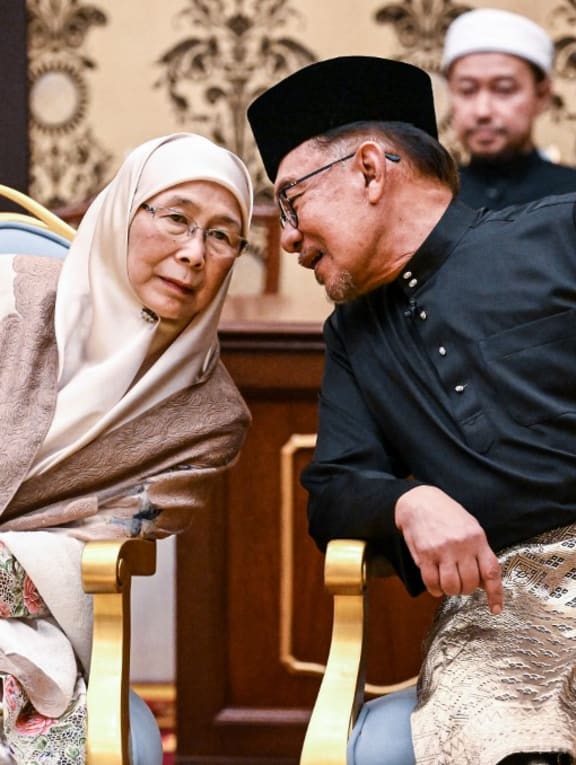 Malaysia's newly appointed Prime Minister Anwar Ibrahim and his wife Wan Azizah Wan Ismail taking part in the swearing-in ceremony at the National Palace in Kuala Lumpur on Nov 24, 2022.
