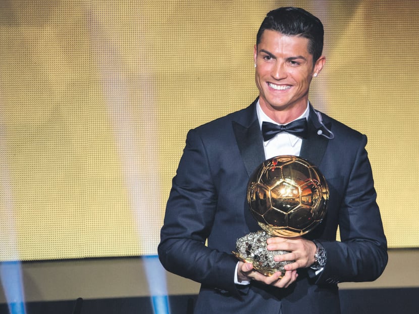Ronaldo with the 2014 Ballon d’Or trophy he received on Monday. He played a pivotal role in Real Madrid clinching their 10th Champions League title last season. Photo: Getty Images