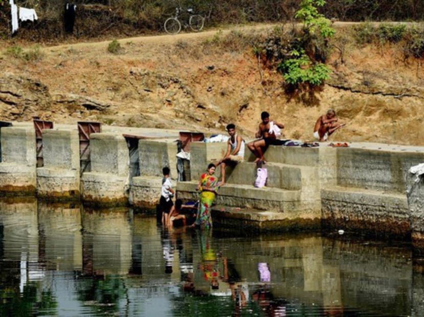 Villagers bathing at the Barighat Dam water reservoir in Tikamgarh in the central Indian state of Madhya Pradesh. Armed men have been securing the dam for months against water thefts by farmers. PHOTO: AFP