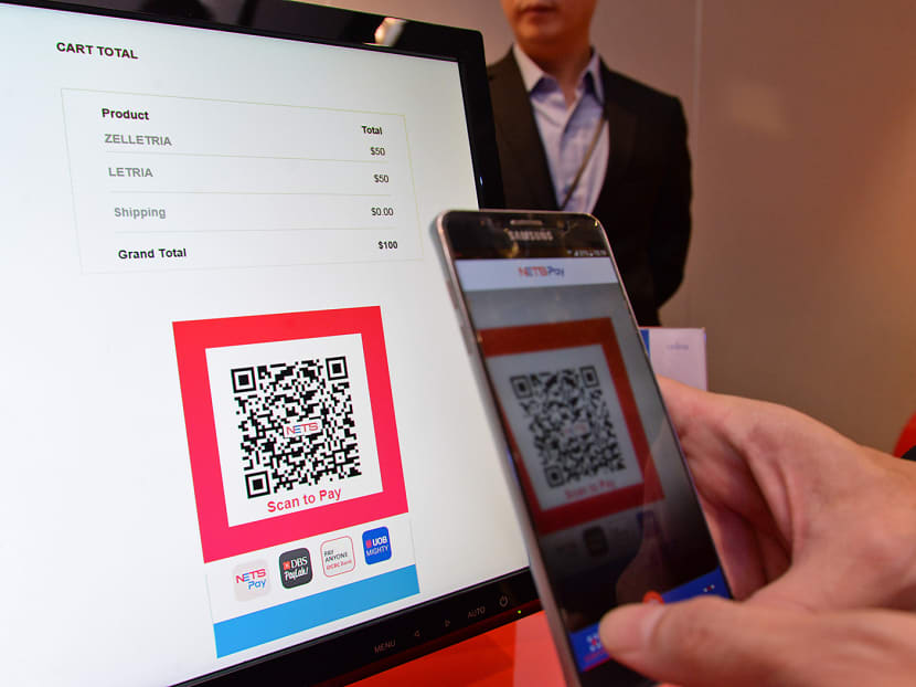 A consumer making an e-commerce transaction using the NETS QR code. TODAY file photo