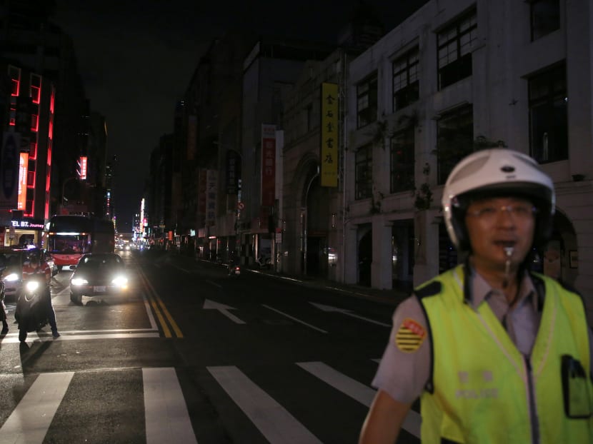 A police officer on duty in Taipei during the massive power outage that hit Taiwan on Aug 15, 2017. Photo: Reuters