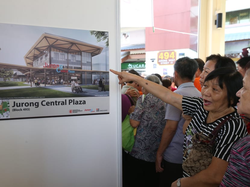 Residents look at artists' impressions of the Jurong Central's new market, which will be replacing the market at Blk 493, Jurong West  St 41 that was damaged by a fire. The design of the new complex was unveiled by Jurong GRC's MP Mr Ang Wei Neng on Sunday (Dec 17). Photo: Ooi Boon Keong/TODAY