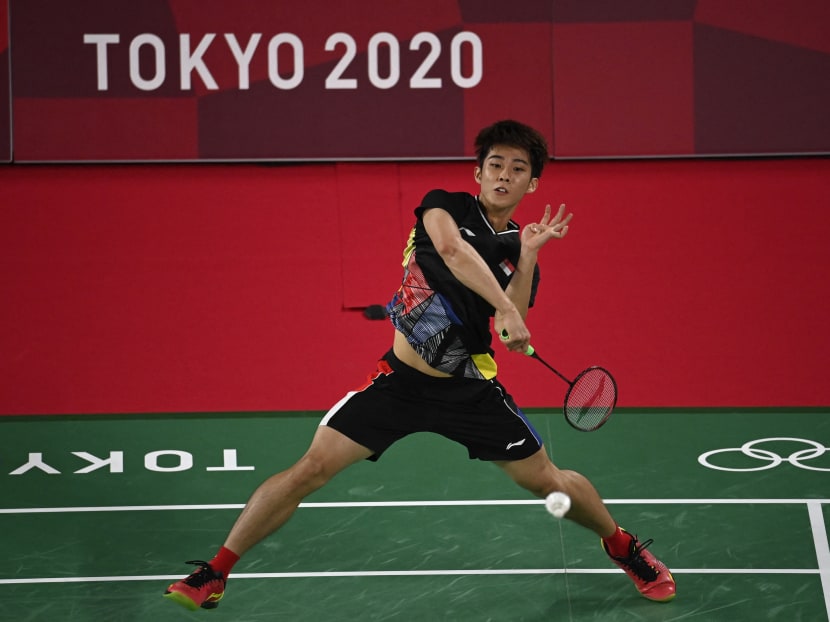 Singapore's Loh Kean Yew hits a shot to Refugee Olympic Team's Aram Mahmoud in their men's singles badminton group stage match during the Tokyo 2020 Olympic Games at the Musashino Forest Sports Plaza in Tokyo, Japan on July 26, 2021.