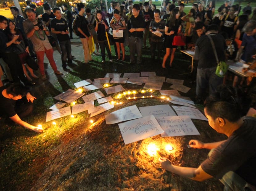 Supporters of Hong Kong's Umbrella Revolution lighting up candles during a vigil at Speakers' Corner, Hong Lim Park in 2014. The Human Rights Watch says the Singapore Government is more interested in public grandstanding than having a substantive discussion about threats to the internationally protected rights to freedom of expression and assembly. Reuters file photo.