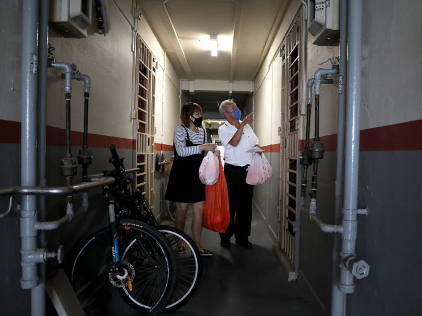Mr Donny Ng, 63, a taxi driver, and his wife Foo Powl Lian, 57, distribute packed lunches to seniors living in one-room rental flats in Ang Mo Kio on Wednesday (May 6) as part of YMCA's Wok the Talk initiative to provide hawker meals and grocery packs to vulnerable groups during the Covid-19 pandemic. Mr Donny Ng, 63, a taxi driver, and his wife Foo Powl Lian, 57, distribute packed lunches to seniors living in one-room rental flats in Ang Mo Kio on Wednesday (May 6) as part of YMCA's Wok the Talk initiative to provide hawker meals and grocery packs to vulnerable groups during the Covid-19 pandemic.