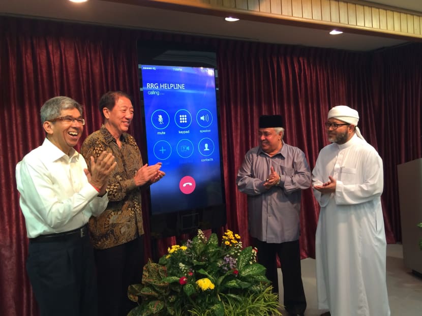 Minister of Communication and Information Dr Yaacob Ibrahim (L), Deputy Prime Minister Teo Chee Hean, Ustaz Ali Haji Mohamed and Ustaz Mohammad Hasbi Hassan (R) launching the RRG helpline. Photo: Louisa Tang