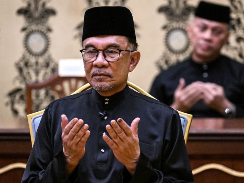 Malaysia's newly appointed Prime Minister Anwar Ibrahim offers prayers after taking the oath during the swearing-in ceremony at the National Palace in Kuala Lumpur Malaysia on Nov 24, 2022. 
