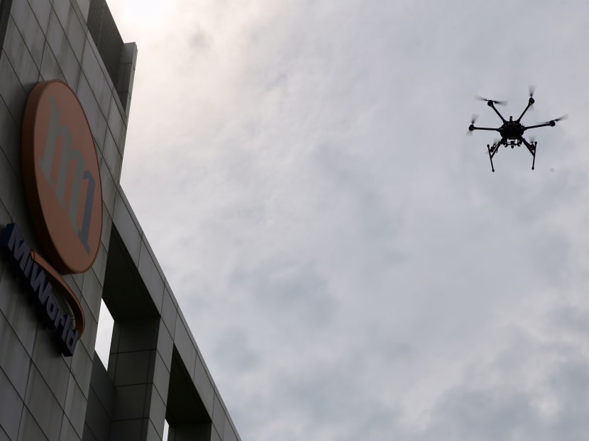 A research partnership inked on Thursday (Dec 7) could one day enable hundreds of drones to safely deliver parcels, or survey and inspect a given area, along pre-determined routes at the same time. Photo: Koh Mui Fong/TODAY