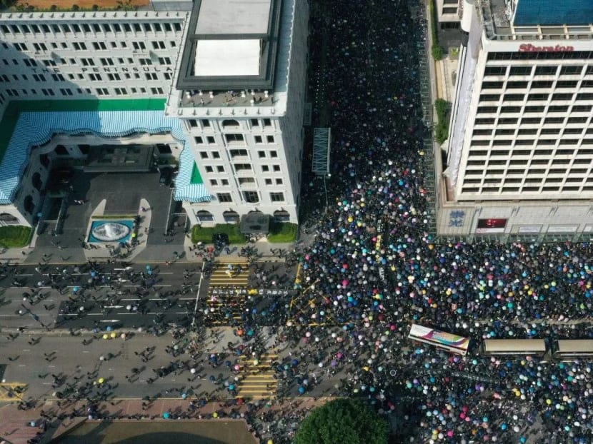 Aerial drone view of buses trapped amongst anti-government protesters in Tsim Sha Tsui, between The Peninsula hotel (left) and Sheraton Kowloon (right) on 20 October 2019.