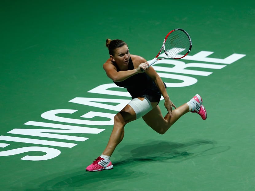 Simona Halep of Romania in action against Eugenie Bouchard of Canada during day one of the BNP Paribas WTA Finals tennis at the Singapore Sports Hub on Oct 20, 2014 in Singapore. Photo: Getty Images