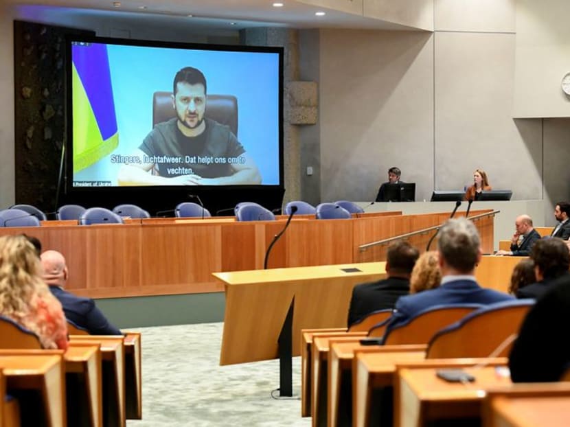 FILE PHOTO: Ukrainian President Volodymyr Zelenskiy appears on screen as he addresses the members of Dutch parliament via video link, amid Russia's invasion of Ukraine, in The Hague, Netherlands,  March 31, 2022. REUTERS/Piroschka Van De Wouw