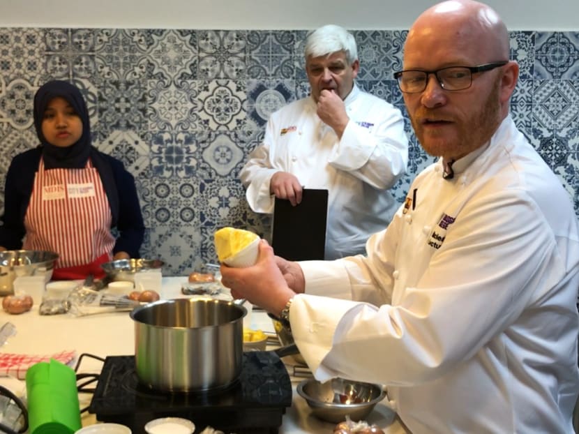MasterChef Gary MacLean is seen in MDIS' new baking studio. He and Willie McCurrach, ‎Head of School for Food Hospitality and Tourism - ‎City of Glasgow College (seen behind MacLean) were showing invited guests how to make chocolate fondant with berry compote. Photo: Sonia Yeo