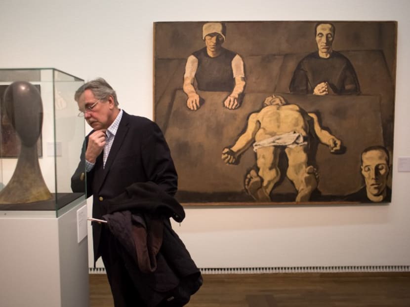 A visitor looks at artworks at the opening of the exhibition "Hidden treasures of the collection" in Leopold Museum in Vienna on January 28, 2016. The Leopold Museum looks for patrons for the works in its collection that are in need of restoration but which have not yet been restored due to a lack of time or funds. Photo: AFP
