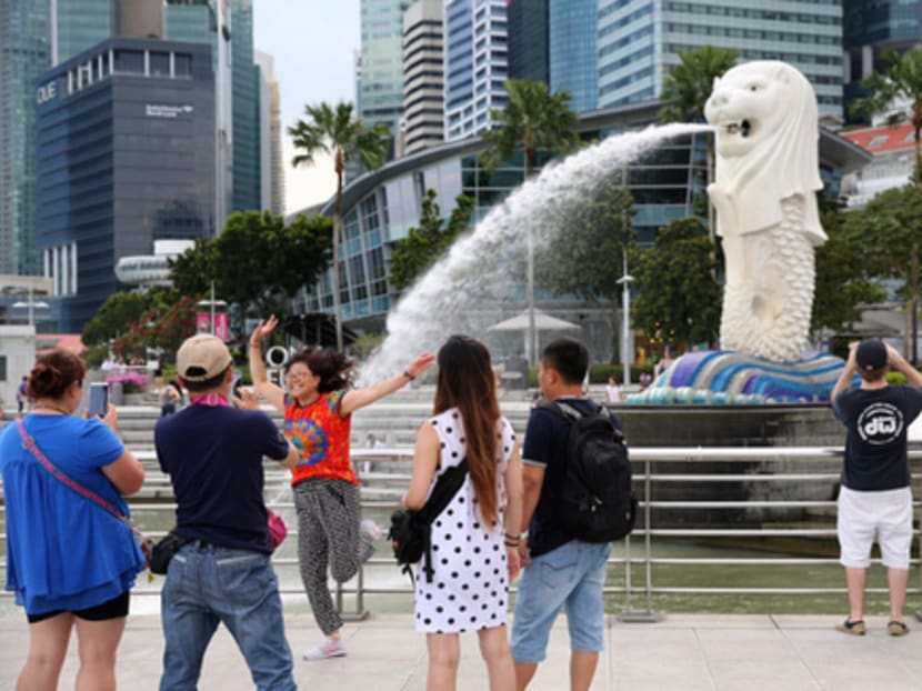 Tourists at the Merlion Park in the central business district. The  tourism industry is expected to face headwinds if the Singapore dollar continues to appreciate against regional currencies such as the Malaysian ringgit and Indonesian rupiah. Photo: Reuters