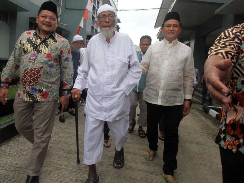Abu Bakar Bashir (centre), the alleged mastermind of the 2002 Bali bombings, walks as he is visited by Yusril Ihza Mahendra (right), who is the lawyer of President Joko Widodo, at Gunung Sindur prison in Bogor, Indonesia, on Jan 18.