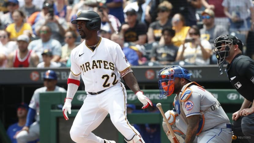 Pittsburgh Pirates center fielder Jack Suwinski reaches for a ball