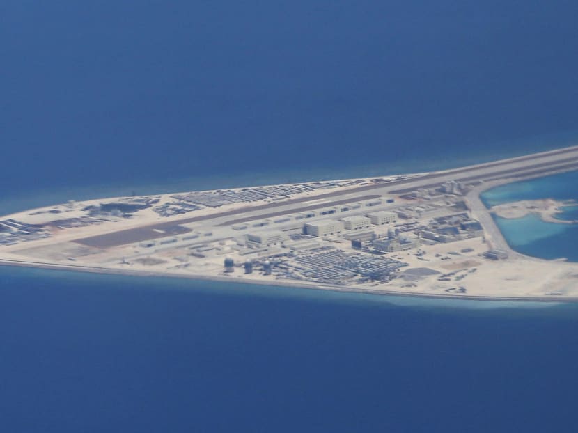 In this April 21, 2017 file photo, Chinese structures and an airstrip on the man-made Subi Reef at the Spratly group of islands in the South China Sea are seen from a Philippine Air Force C-130.  Photo: AP