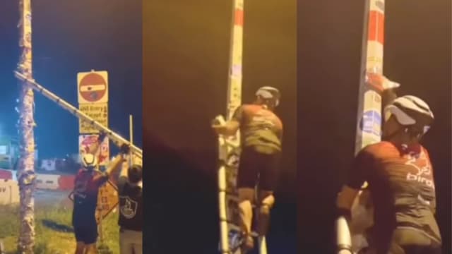 大士1号灯柱“贴出新高度” 脚踏车骑士爬梯子“打卡”