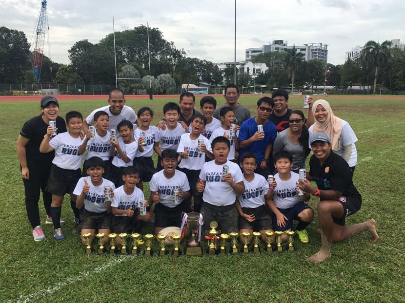 The jubilant Endeavour Primary School rugby team with coach Peerose Shah (right, with cap), teachers and their National Primary Schools Under-11 title. Photo: Yaidi Mohamad