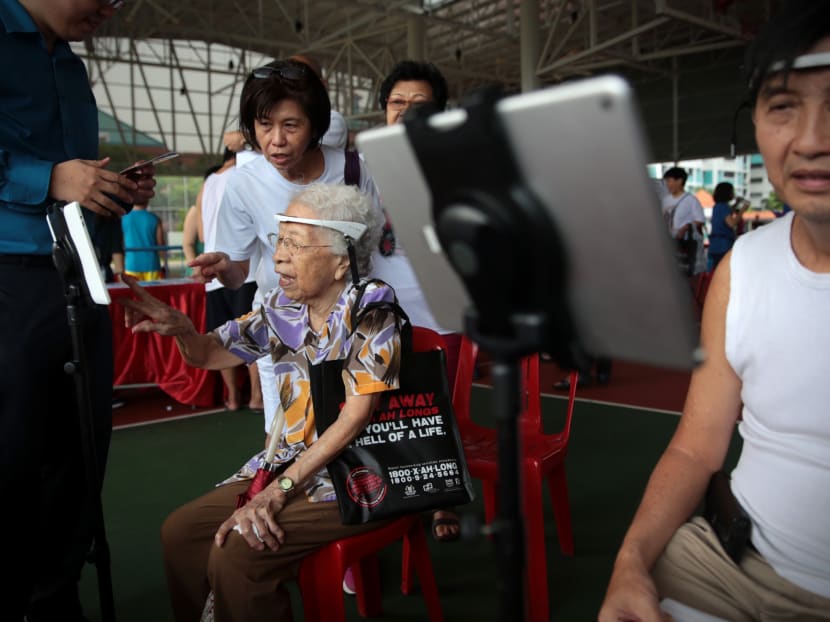 Attendees play brain training games as they try out a brain fitness programme for seniors at a booth at a dementia forum at Nee Soon South on Sunday (Nov 12). Photo: Jason Quah/TODAY