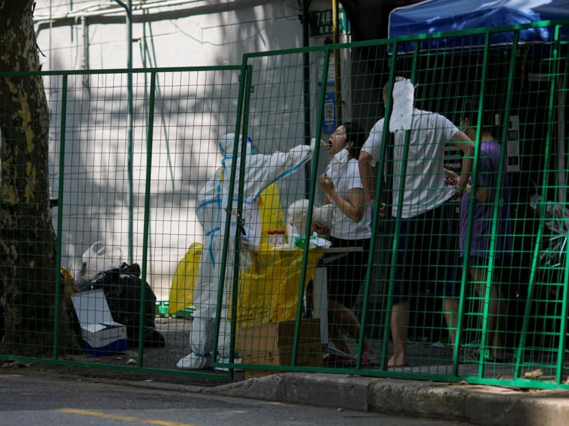 <p>A resident gets tested for Covid-19 behind barriers of a sealed area, amid new lockdown measures in parts of the city to curb the Covid-19 outbreak in Shanghai, China on June 17, 2022.&nbsp;</p>
