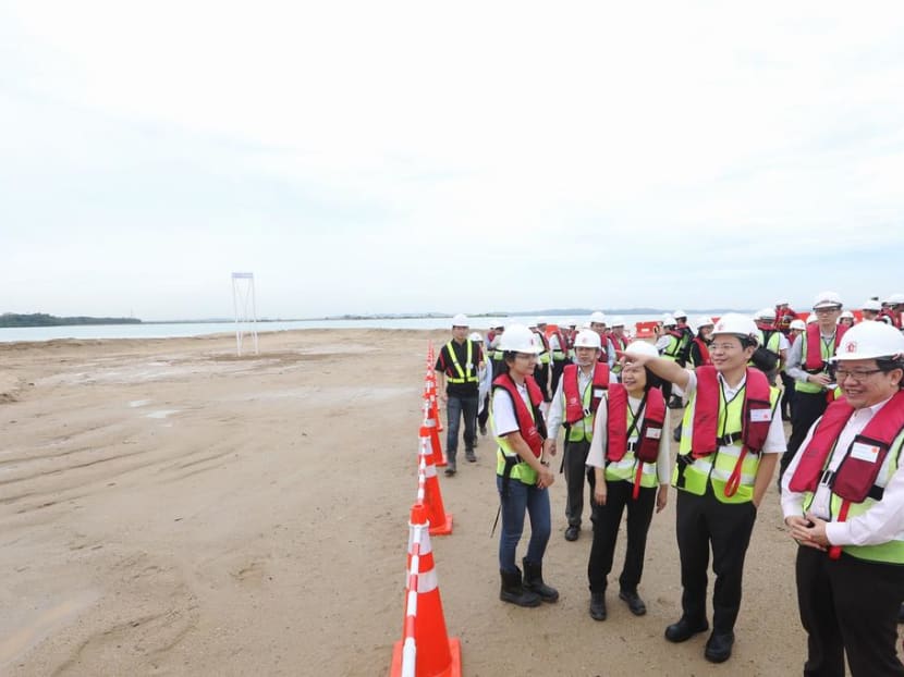 Officials including National Development Minister Lawrence Wong (second from right) during a 2016 visit to the site of the polder being built on Pulau Tekong, which is about the size of two Toa Payoh towns. Construction is still under way. Officials including National Development Minister Lawrence Wong (second from right) during a 2016 visit to the site of the polder being built on Pulau Tekong, which is about the size of two Toa Payoh towns. Construction is still under way.