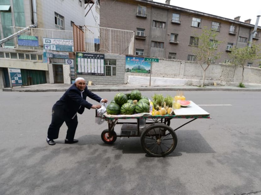 A vendor pushing his cart in Xinjiang's Urumqi. Xinjiang authorities have abruptly cancelled the week-long National Day holiday “to prepare” for the Communist Party congress later this month. Photo: AFP