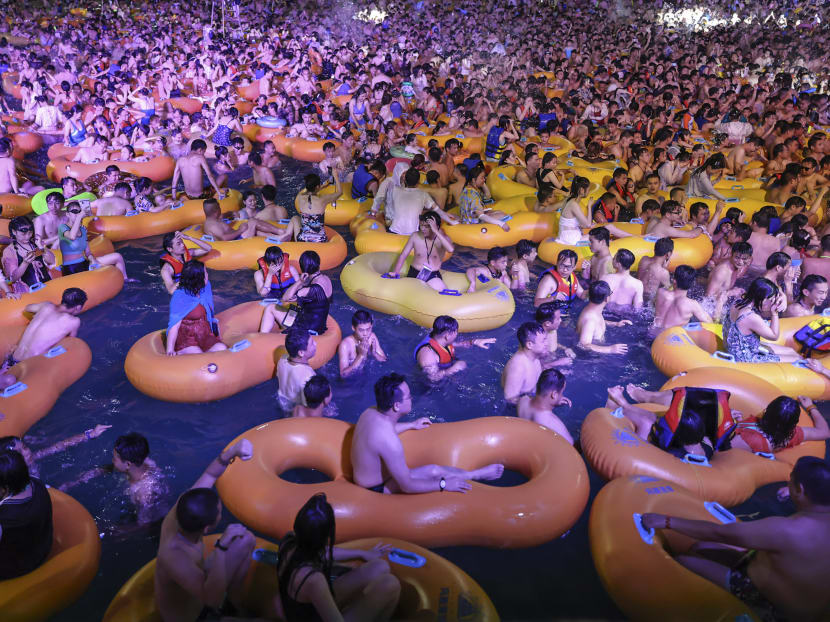 This photo taken on Aug 15, 2020 shows people watching a performance as they cool off in a swimming pool in Wuhan in China's central Hubei province.