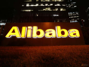 FILE PHOTO: The logo of Alibaba Group is lit up at its office building in Beijing, China August 9, 2021. REUTERS/Tingshu Wang