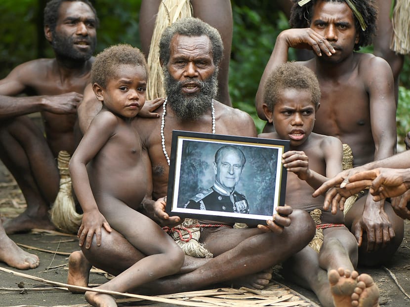 Yakel village chief Albi, and members of his family, holds a portrait of Britain's Prince Philip, Duke of Edinburgh, in the remote Pacific village of Vanuatu on April 12, 2021.