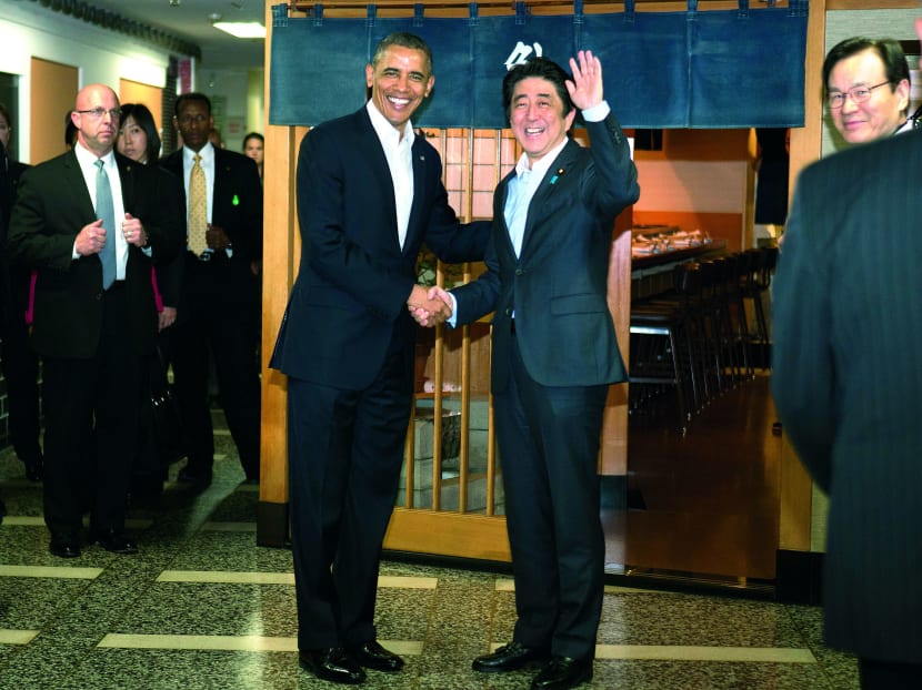 OBAMA DREAMS OF SUSHI  United States President Barack Obama (left) and Japanese Prime Minister Shinzo Abe shaking hands before having dinner at the famous Sukiyabashi Jiro sushi restaurant in Tokyo yesterday. (See story on page 14) Photo: AP