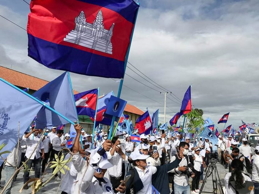 Supporters of the opposition party, Candlelight Party, wave flags as they take part in a campaign rally for the upcoming local elections due to be held on June 5, in Phnom Penh, Cambodia