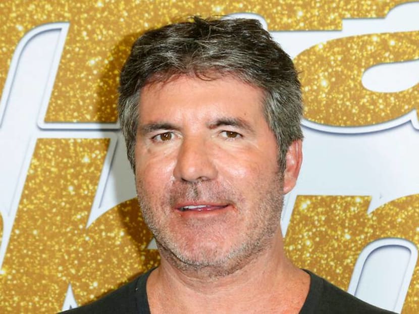Simon Cowell breaks back, has surgery after falling off new electric bicycle Simon Cowell breaks back, has surgery after falling off new electric bicycle