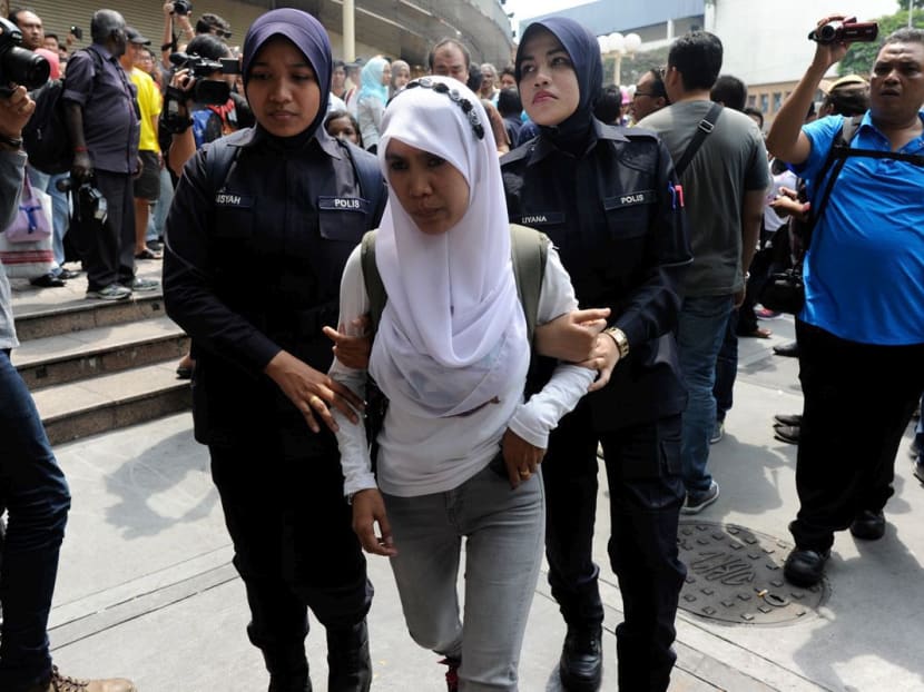 A young woman is arrested for being part of the #TangkapNajib rally outside the Sogo Department Store in Jalan Tuanku Abdul Rahman in Kuala Lumpur today (Aug 1). Photo: The Malaysian Insider