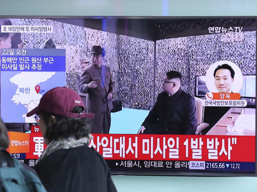 Visitors walk by the TV screen showing the news programme with a file footage of North Korean leader Kim Jong Un at the Seoul Train Station in Seoul on March 22, 2017. Photo: AP