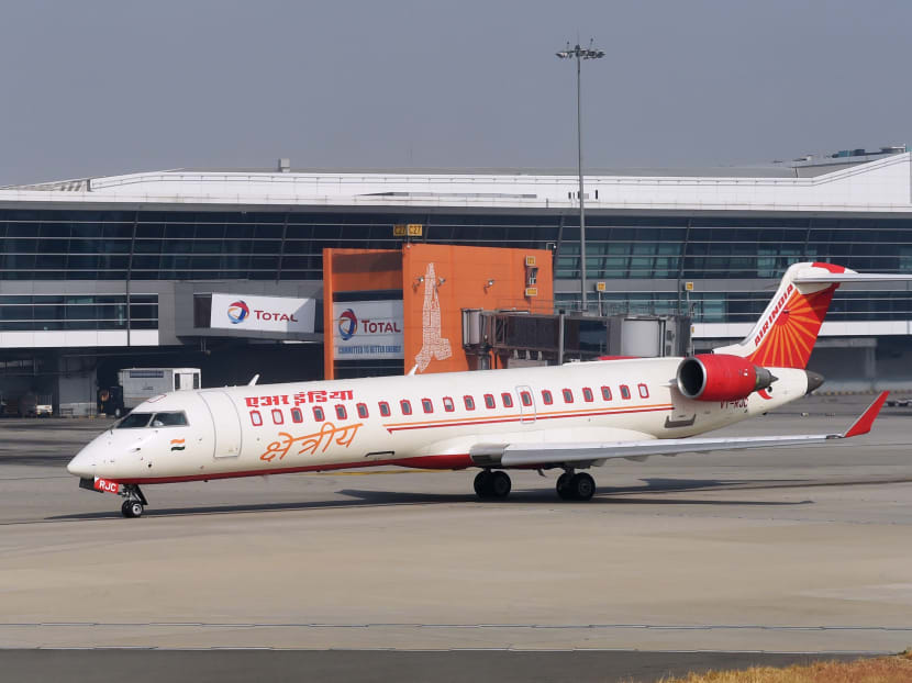 A jet belonging to the Indian carrier Air India rolls past the main terminal of the Indira Gandhi International airport prior to take-off in New Delhi. Photo: AFP