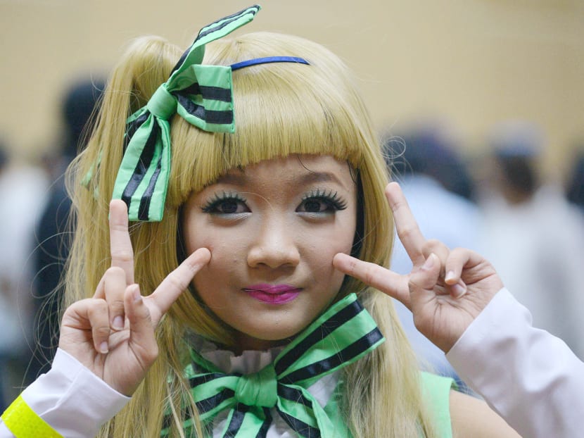 This photo taken on April 23, 2016 shows a Burmese cosplayer posing for a photograph at a cosplay festival in Yangon. Purple-haired princesses, wolves and dolled-up maids mingled at a 'cosplay' fantasy costume festival held this weekend in Myanmar, where the global role-playing craze is building up a cult following. Photo: AFP
