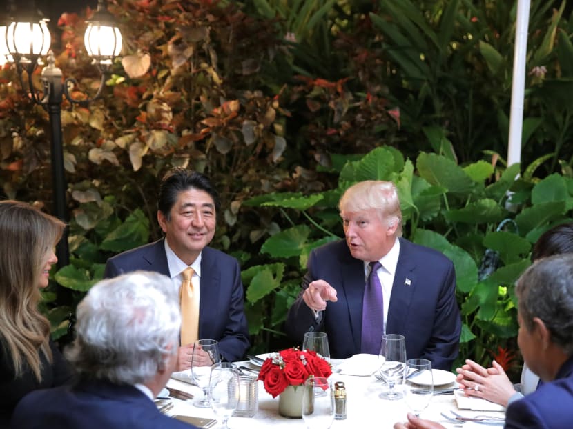 Japanese Prime Minister Shinzo Abe and Akie Abe (right, partially obscured) attend dinner with US President Donald Trump his wife Melania, and Robert Kraft (2nd-left), owner of the New England Patriots at Mar-a-Lago Club in Palm Beach, Florida on Feb 10, 2017. Photo: Reuters