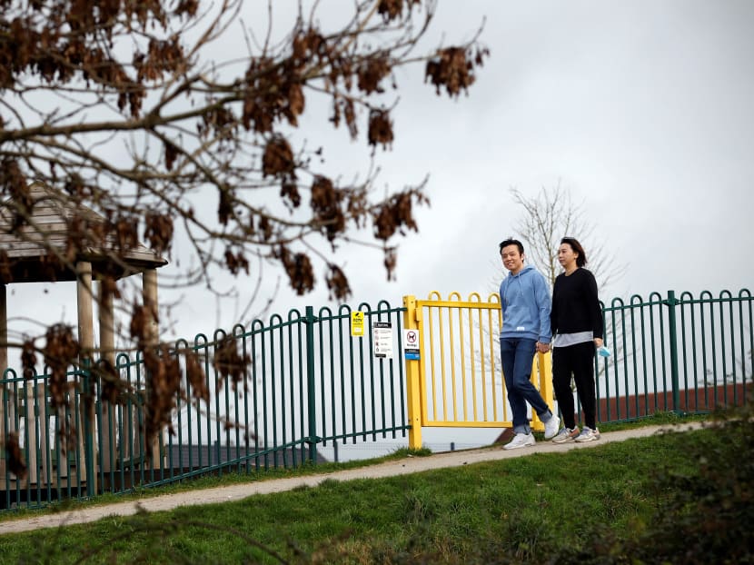 This photo taken on January 28, 2021 shows Mr Gavin Mok and his wife Lydia, who arrived last year from Hong Kong, exploring the local park near their new home in Exeter. A new visa scheme is offering millions of Hong Kongers a pathway to British citizenship as the city's former colonial master opens its doors to those wanting to escape China's crackdown on dissent.