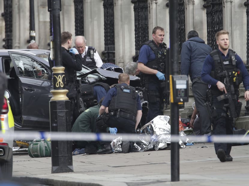 In this March 22, 2017 file photo, emergency personnel tend to an injured person outside Britain's Parliament. The attack was claimed by the Islamic State group. AP file photo